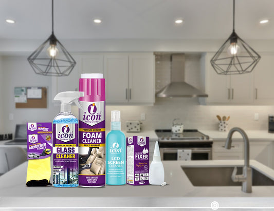 Collection of cleaning products on a kitchen counter with a modern kitchen background